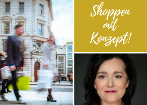 Menschen gehen auf einer Einkaufsstraße und haben Einkaufstaschen in der Hand.